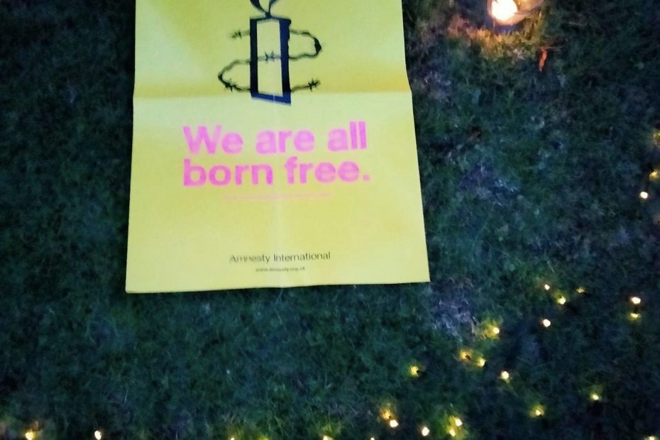 Candle and lights with an Amnesty International Poster